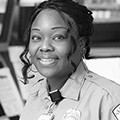 Woman in a security uniform smiling at the camera